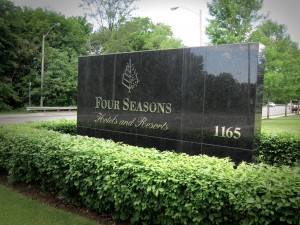 Photo of Four Seasons sign and shrubs